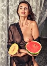 Hot chick poses with her sexy melons and a watermelon