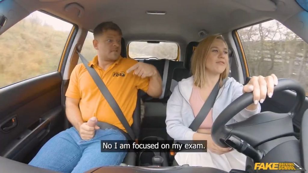 Man sits next to a blonde driving the car with his dick out