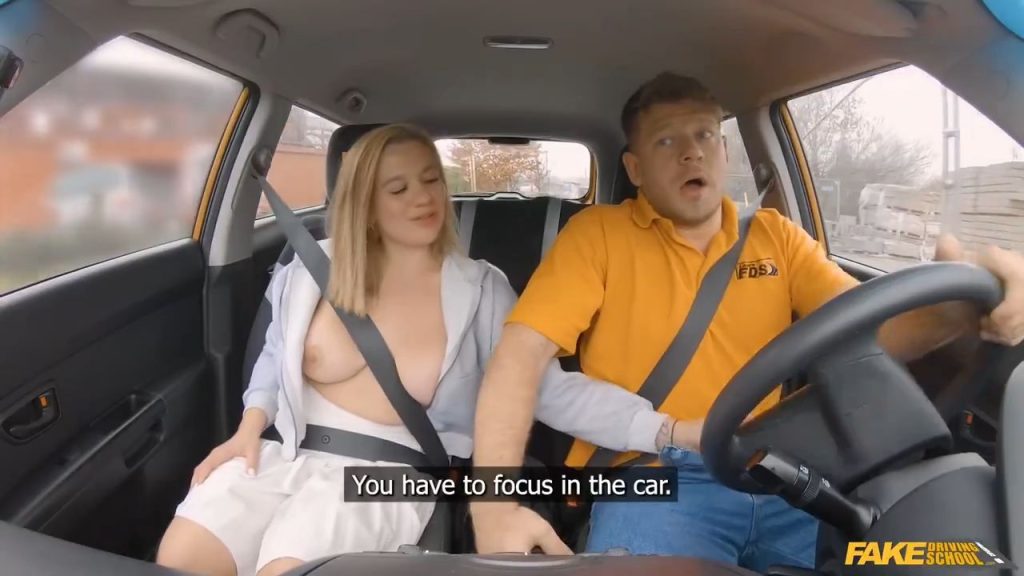 Man drives car while busty blonde has her tits out